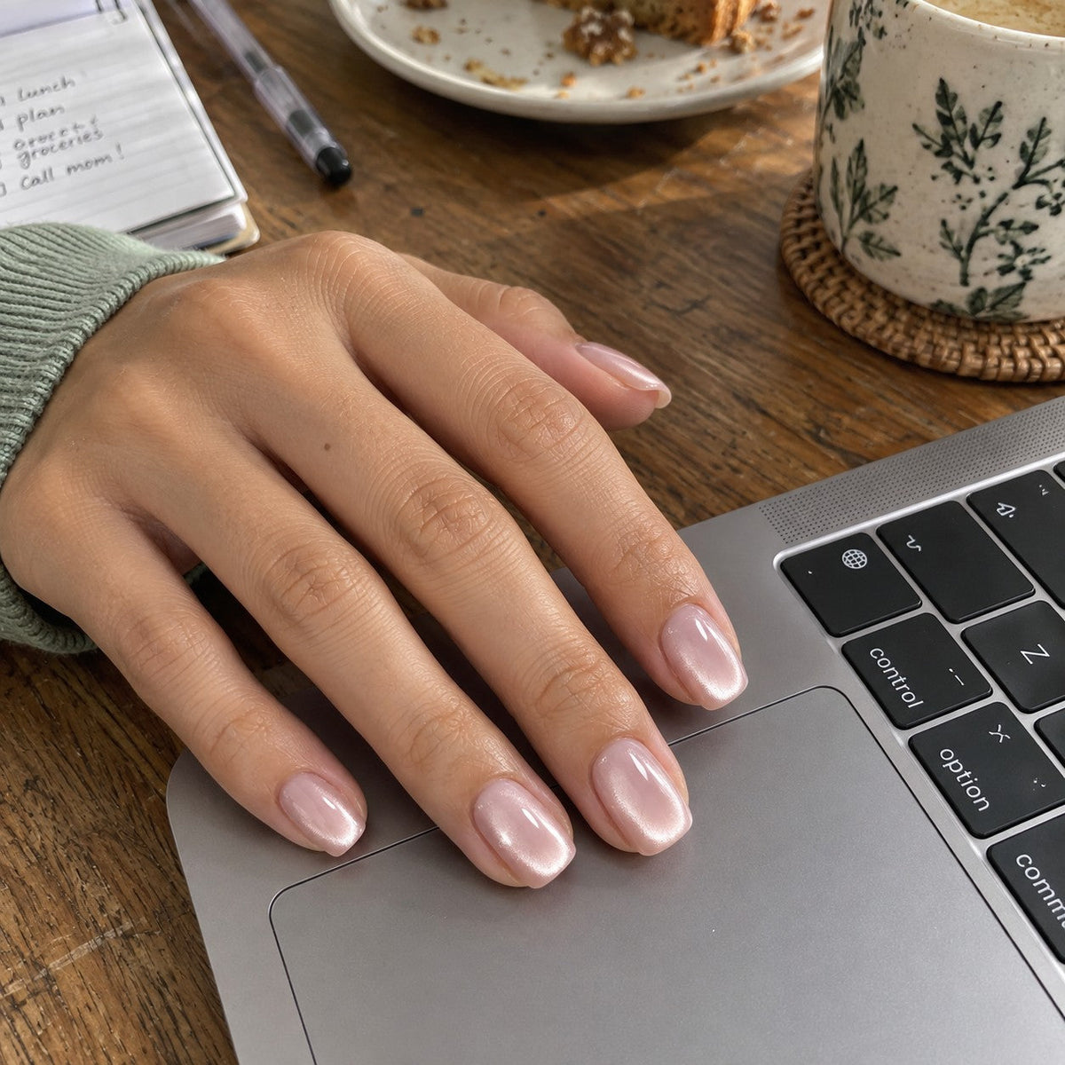 Flower Wine cat-eye nails resting on a laptop