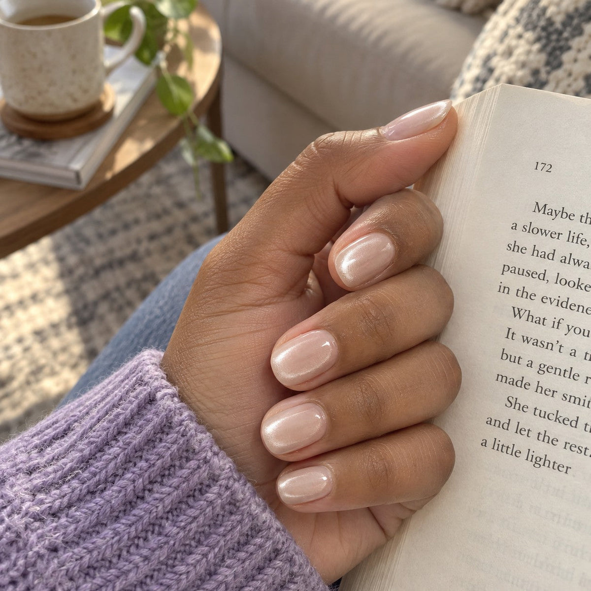 Eaves Rain cat-eye nails holding an open book