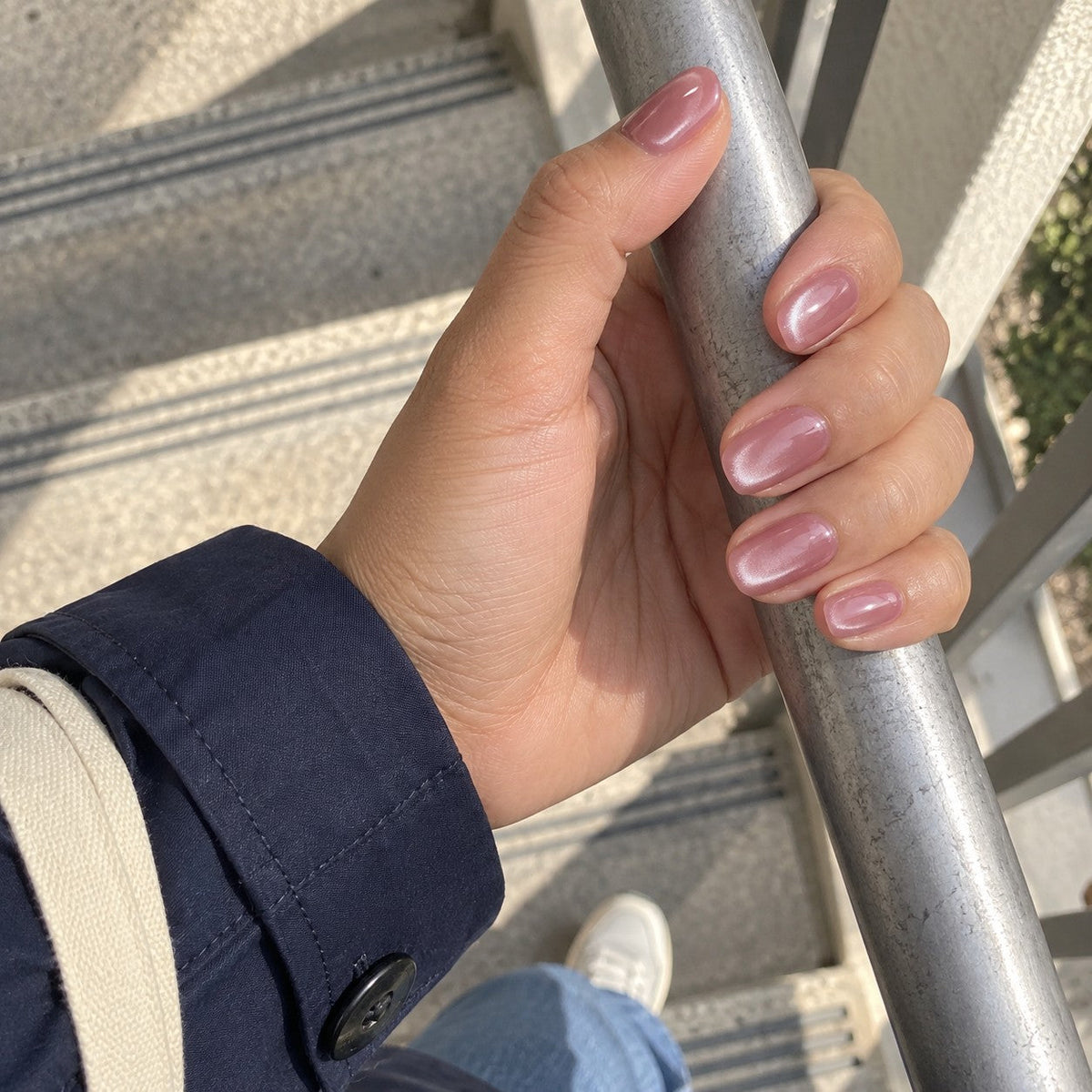 Brocade cat-eye nails on a stair rail